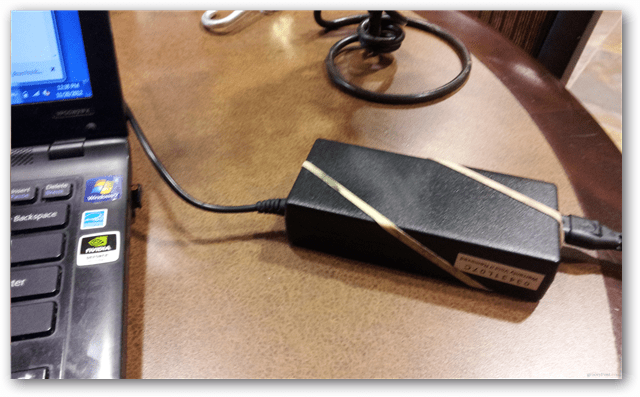 Voorkom dat de stroomvoorziening van uw laptop met een rubberen band over een bureau glijdt